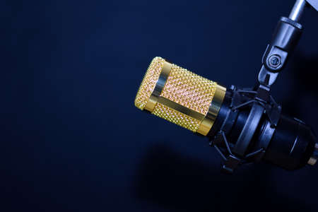 Close-up of retro microphone isolated on bokeh black backgroundの写真素材