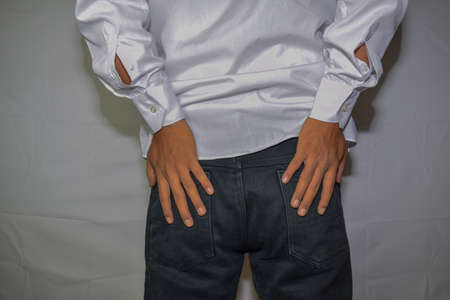 Close up Asian man shows he had hemorrhoid symptoms rectal cancer isolated on white background