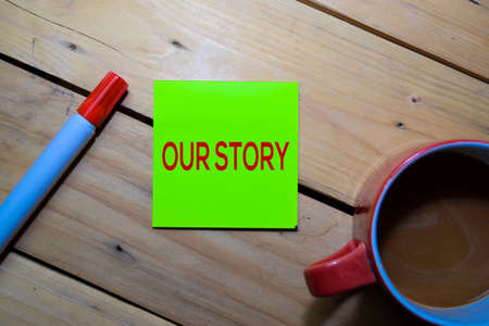 Our Story text on the sticky notes isolated on table backgroundの写真素材
