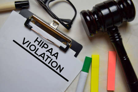 Hipaa Violation text on Document and gavel isolated on office desk.の写真素材