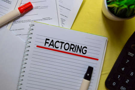 Factoring text on a book isolated on office desk.の写真素材