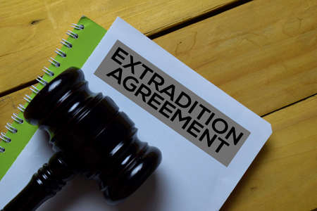 Extradition Agreement Document form and Black Judges gavel on wooden desk. Law conceptの写真素材