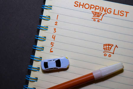 Shopping List text on a book isolated on office desk.の写真素材
