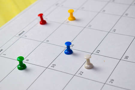 Close up Pinboard on white calendar. Schedule, reminder concept