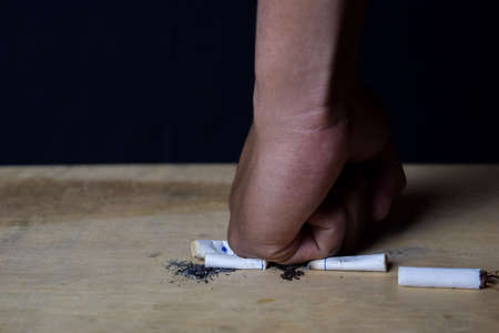 Man destroy cigarettes. Stop smoking or healthcare concept