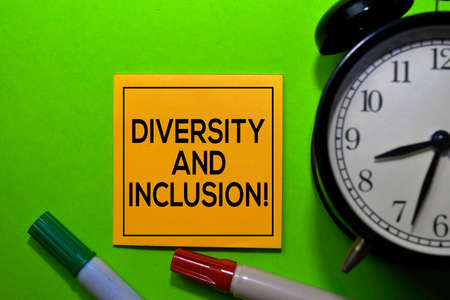 Diversity and Inclusion! write on sticky notes isolated on green background.の写真素材