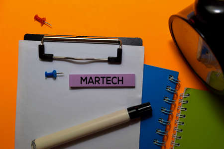 Martech write on sticky notes. Isolated on orange table backgroundの写真素材