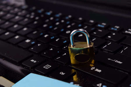 gold padlock. digital data protection isolated on laptop keyboard background. Security conceptの写真素材