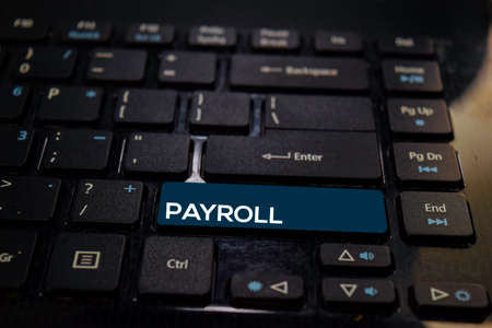 Payroll write on keyboard isolated on laptop backgroundの写真素材