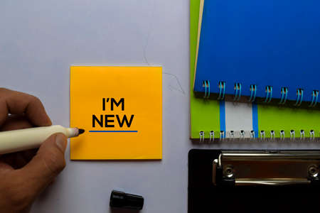 I'm New write on sticky notes. Isolated on white table background