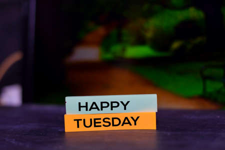 Happy Tuesday on the sticky notes with bokeh backgroundの写真素材
