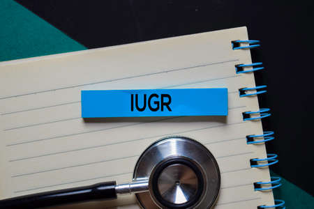 IUGR text on sticky notes. Office desk background. Medical or Healthcare concept