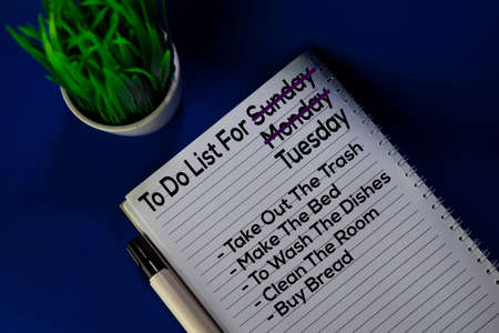 To Do List For Tuesday write on book with schedule isolated blue background. Routine concept