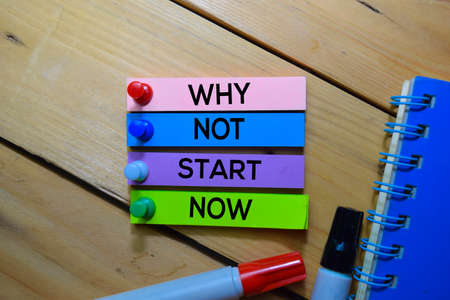 Why Not Start Now text on sticky notes isolated on the tablesの写真素材