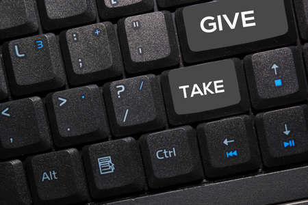 Give and Take write on keyboard isolated on laptop background
