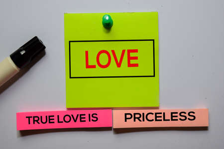Love. True Love Is Priceless text on sticky notes isolated on office desk