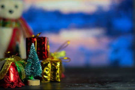 Close up decoration snowman and christmas tree isolated on bokeh background. selective focus on christmas treeの写真素材