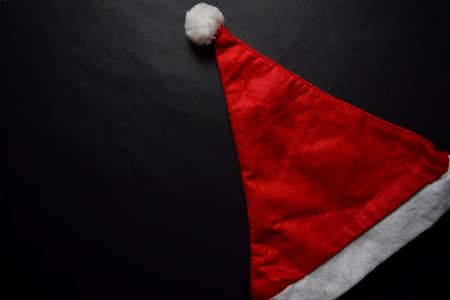 Santa Claus red hat isolated on black backgroundの写真素材