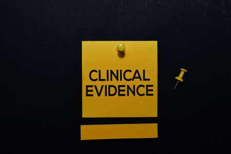 Clinical Evidence write on sticky notes isolated on office desk. medical and education concept.の写真素材
