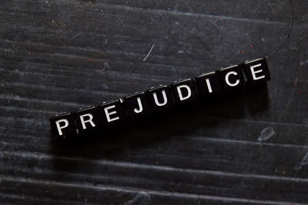 Prejudice on wooden cubes. On table backgroundの写真素材