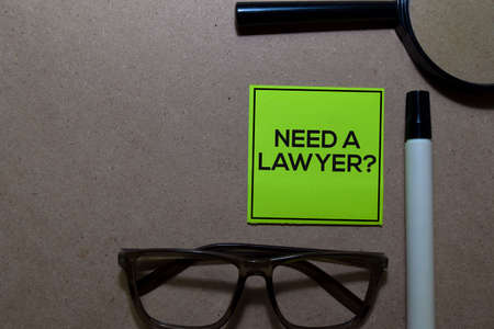 Need a Lawyer? write on sticky notes isolated on Office Deskの写真素材