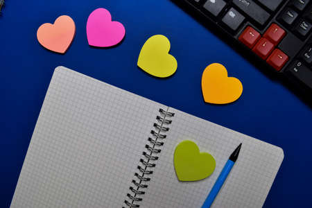 Close up a book and Keyboard on blue table background