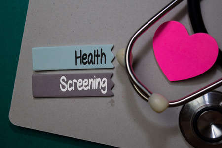 Health Screening write on stick note isolated on Office Desk. Healthcare conceptの写真素材