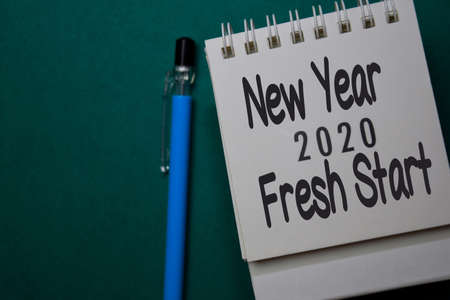 New Year Fresh Start in 2020 write on calendar isolated on office desk background