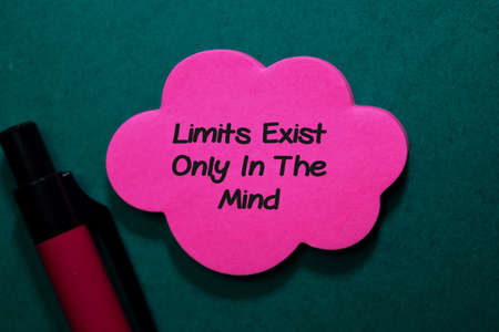 Limit Exist Only in The Mind write on stick note isolated on Office Deskの写真素材
