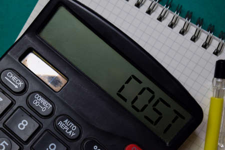 Cost write on the calculator with white board backgroundの写真素材