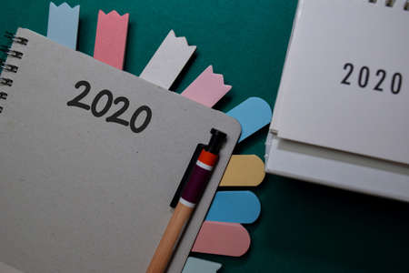 2020 write on a book and calendar isolated on Office Deskの写真素材