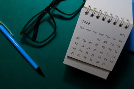 White Calendar July 2020 on office desk backgroundの写真素材