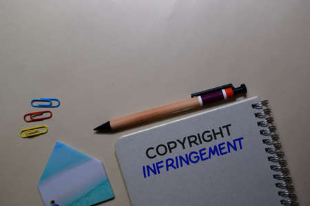 Copyright Infringement write on a book isolated on Office Deskの写真素材