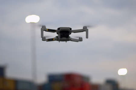 Close up Fly Grey Drone on Port Industrial Jakarta. selective focus on drone