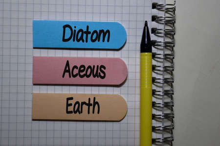 Diatom Aceous Earth write on sticky note isolated on Office Desk.