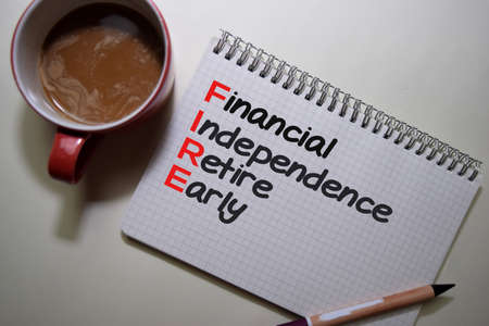 Financial Indipendence Retire Early write on a book isolated on Office Desk.の写真素材