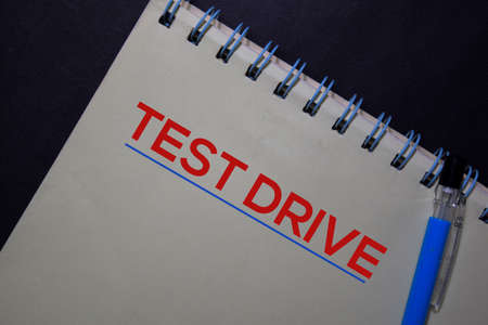 Test Drive write on a book isolated on black table.の写真素材
