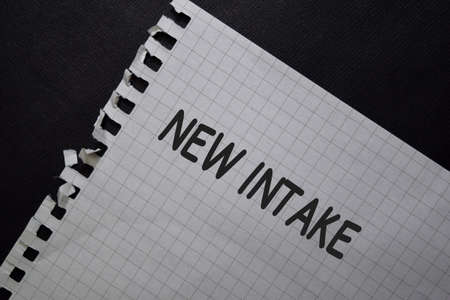 New Intake write on a paperwork isolated on black table.の写真素材