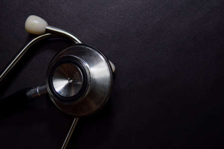 Close up Black Stethoscope isolated on black tableの写真素材