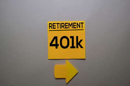 Retirement 401k write on a sticky note isolated on office desk.の写真素材