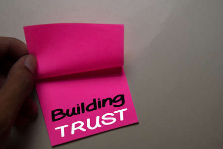Building Trust write on a sticky note isolated on office desk.の写真素材