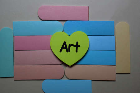Art write on a sticky note isolated on office desk.