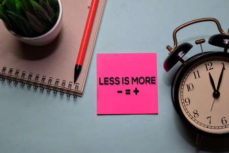 Less is More write on a sticky note isolated on office desk.の写真素材