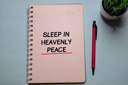 Sleep in Heavenly write on a book isolated on office desk. Christian faith conceptの写真素材