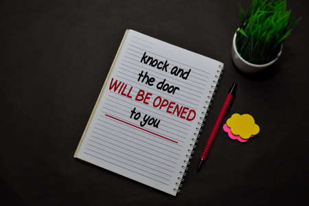 Knock and the Door Will Be Opened to You write on a book isolated on office desk. Christian faith conceptの写真素材