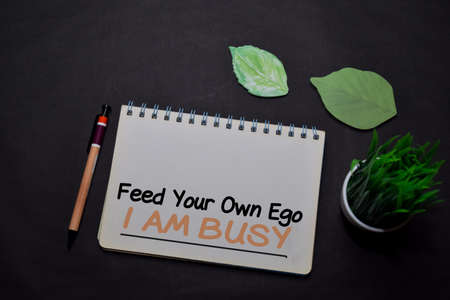 Feed Your Own Ego I am Busy write on a book isolated on office desk. Christian faith concept