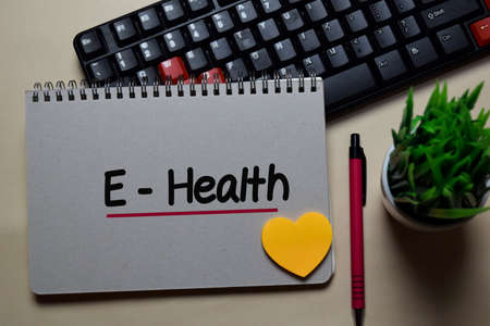 E-Health write on a book isolated on office desk.