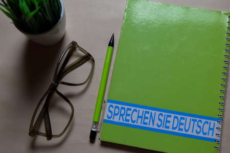 Sprechen Sie Deutsch write on a book isolated on Office Desk. German language it means do you speak germanの写真素材