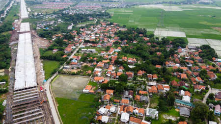 Aerial Shot. Bridge under construction and The edge of an urban river with housesの写真素材