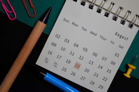 Top view August monthly Calendar and marked 19th aviation day isolated on office desk